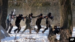 FILE - Members of a Georgian Legion train civilians to adapt them with the self-defense capabilities in case of a Russian invasion in Kyiv, Feb. 4, 2022.