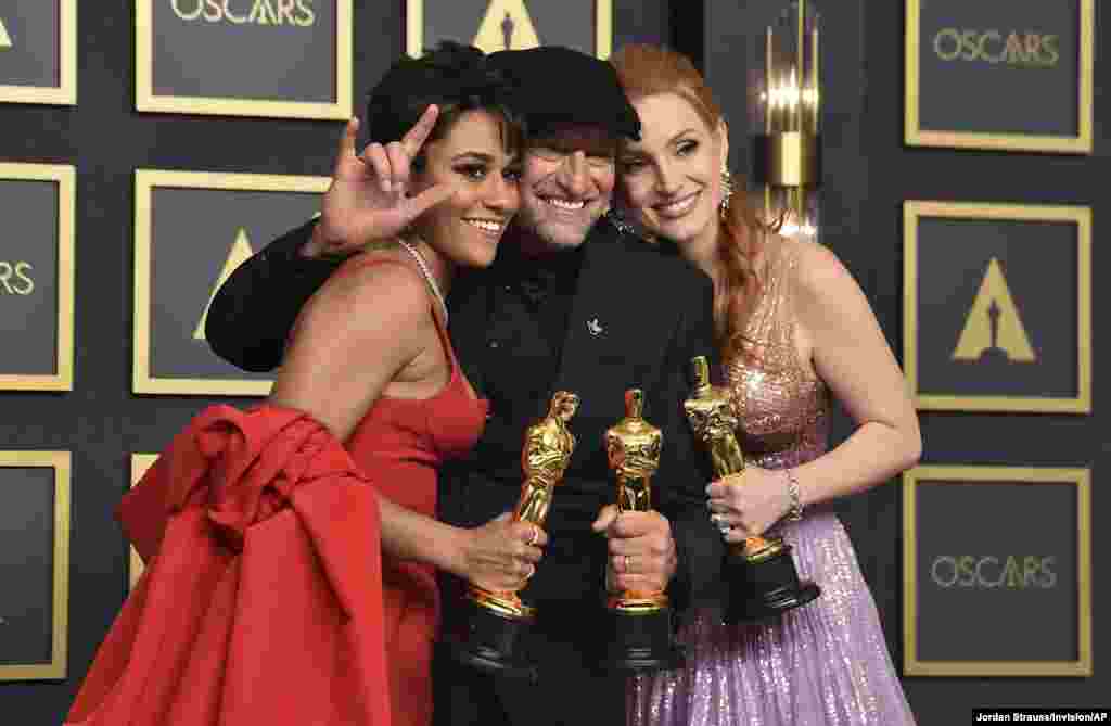 Ariana DeBose (left), winner of the award for the best actress in a supporting role for &quot;West Side Story&quot;, Troy Kotsur (center), winner of the award for the best actor in a supporting role for &quot;CODA&quot;, and Jessica Chastain (R) winner of the best actress in a leading role for &quot;The Eyes of Tammy Faye,&quot; stand in the press room at the Oscars, March 27, 2022, at the Dolby Theatre in Los Angeles.