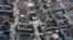 This satellite photo provided by Maxar Technologies March 19, 2022, shows the aftermath of an airstrike earlier in the week on the Mariupol Drama Theater, in Mariupol, Ukraine, and the area around it.