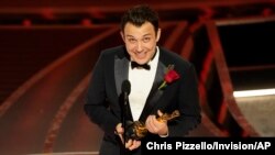 Ben Proudfoot accepts the award for best documentary short subject for "The Queen of Basketball" at the Oscars on Sunday, March 27, 2022, at the Dolby Theatre in Los Angeles.
