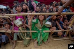 FILE - Rohingya children, who crossed over from Myanmar into Bangladesh, wait squashed against each other to receive food handouts at Thaingkhali refugee camp, Bangladesh, Oct. 21, 2017.