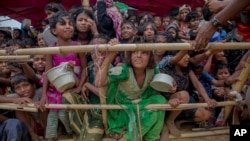 FILE - Rohingya children, who crossed over from Myanmar into Bangladesh, wait squashed against each other to receive food handouts at Thaingkhali refugee camp, Bangladesh, Oct. 21, 2017.
