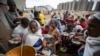 FILE - Tigrayans queue to receive food donated by local residents at a reception center for the internally displaced, in Mekele, in Ethiopia's Tigray region, May 9, 2021. 