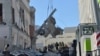 Rescue workers clear the rubble of a building of the Kharkiv Regional Institute of Public Administration damaged by shelling, March 18, 2022, amid Russia's invasion of Ukraine. 
