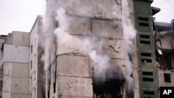 FILE: Smoke rises out of an apartment building damaged by shelling in Chernihiv, Ukraine, March 3, 2022. 