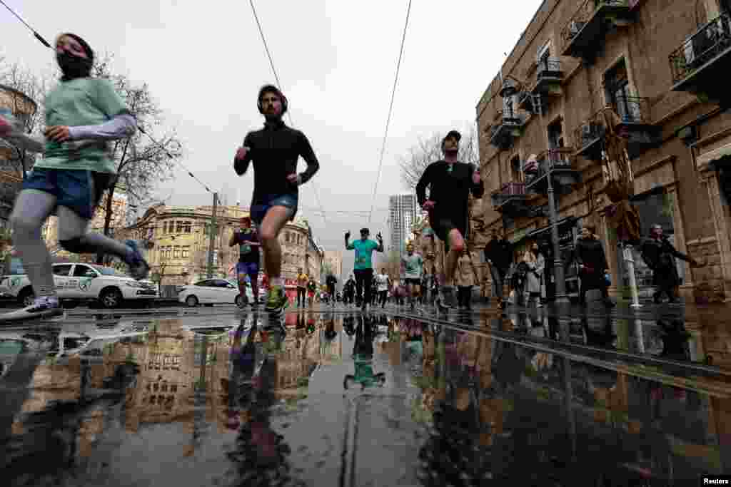 Runners take part in the Jerusalem Marathon, which includes international competitors, after Israel eased COVID-19 restrictions on tourists entering the country, in Jerusalem.