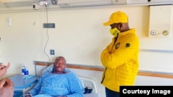 Citizens' Coalition for Change member Godfrey "Madzibaba veShanduko" Karembera at Parirenyatwa Hospital with party president Nelson Chamisa.