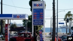 FILE - Gas prices are displayed at a gas station on March 11, 2022, in Long Beach, California.