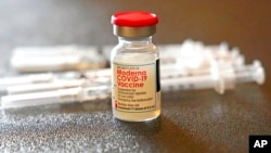 Un envase lleno de la vacuna Moderna contra el COVID-19 junto a jeringuillas el 7 de diciembre de 2021, en un puesto de vacunación junto a la Universidad Estatal de Jackson en Jackson, Mississippi.