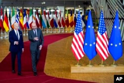 President Joe Biden, left, walks with European Council President Charles Michel during arrival for an EU summit at the European Council building in Brussels, March 24, 2022.