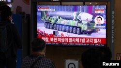 2022年3月24日，在韩国首尔，人们在电视上观看有关朝鲜进行洲际弹道导弹(ICBM)试射的新闻报道。