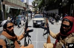 FILE- Taliban fighters patrol in Kabul, Afghanistan, Aug. 19, 2021.