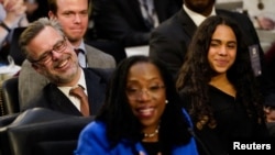 Patrick Jackson, husband of Judge Ketanji Brown Jackson, and their daughter Leila react as the judge answers a question from the US Senate Judiciary Committee on Capitol Hill in Washington, March 23, 2022.