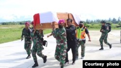 Para anggota TNI membawa peti berisi jenazah rekannya yang gugur dalam serangan yang dilakukan oleh kelompok bersenjata di Nduga, Papua, dalam proses evakuasi menuju Timika, pada 27 Maret 2022. (Foto: Pendam XVII/Cenderawasih Papua)