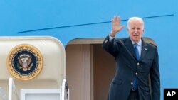 FILE - President Joe Biden waves as he boards Air Force One at Andrews Air Force Base, Md., March 23, 2022.