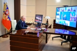 Russian President Vladimir Putin chairs a Security Council meeting via videoconference at the Novo-Ogaryovo residence outside Moscow, Russia, Thursday, March 3, 2022. (Sputnik via AP)