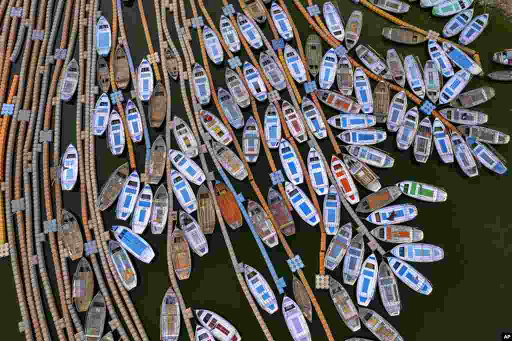 Boats can be seen floating on the Yamuna River in Prayagraj, India, March 28, 2022.