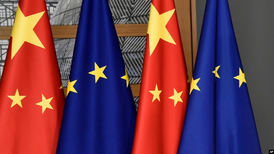 FILE - In this file photo dated Dec. 17, 2019, EU and Chinese flags at the Europa building in Brussels.