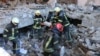 This handout picture taken and released on March 22, 2022, by the Ukrainian State Emergency Service shows rescuers conducting search operations and dismantling debris in Kharkiv.