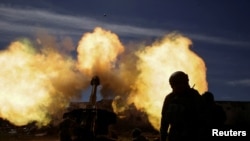 Members of the Ukrainian Volunteer Corps fire with a howitzer, as Russia's attack on Ukraine continues, at a position in Zaporizhzhia region, March 28, 2022. 