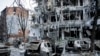 FILE - Damaged vehicles and buildings in Kharkiv city center in Ukraine, March 16, 2022. 