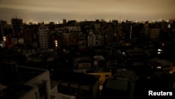 Houses and buildings are seen in an electric stoppage at the area after an earthquake at Toshima ward in Tokyo, Japan March 17, 2022. 