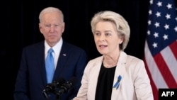 US President Joe Biden listens while European Commission President Ursula von der Leyen makes a statement about Russia in Brussels, on March 25, 2022. 