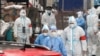 Medical workers in protective suits walk amid the snow as they enter a residential compound under lockdown to conduct testing, following a COVID-19 outbreak in Changchun, Jilin province, China March 14, 2022. (China Daily via Reuters)