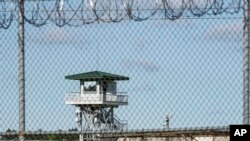 FILE - In this April 16, 2018, photo, a guard tower stands above the Lee Correctional Institution, a maximum-security prison in Bishopville, S.C.