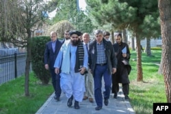 This handout photo released by the Taliban Foreign Ministry shows Taliban Foreign Minister Amir Khan Muttaqi and Kremlin's special envoy to Afghanistan, Zamir Kabulov walking before their meeting in Kabul, March 24, 2022. (Photo by Taliban Foreign Ministry / AFP)
