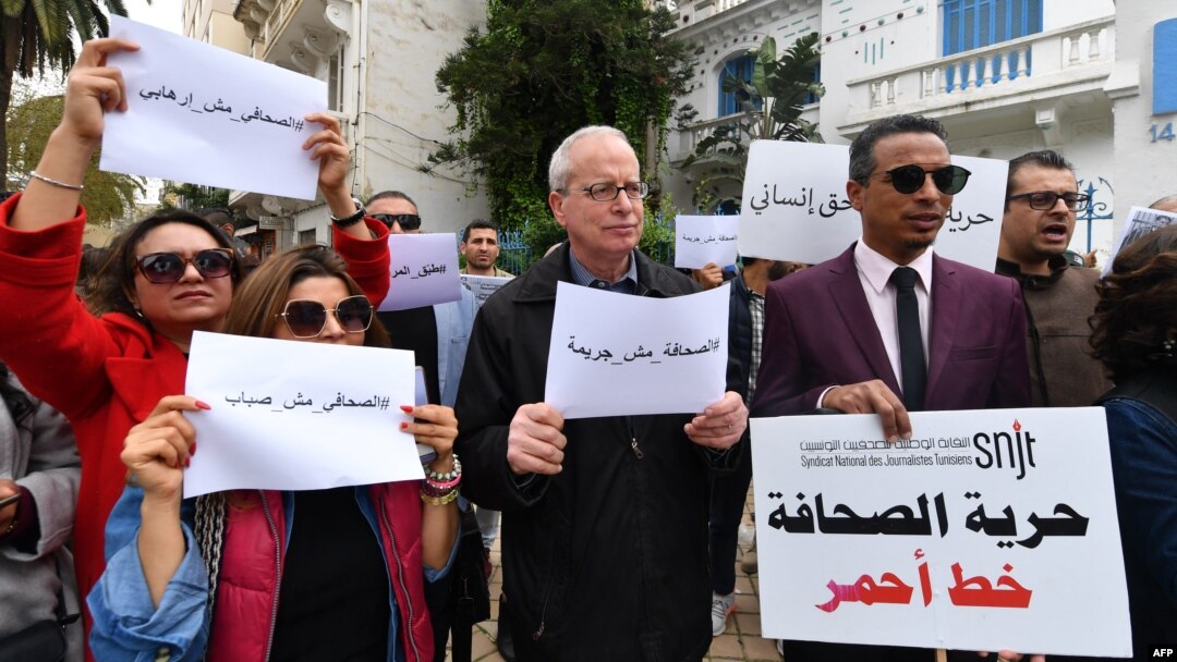 FILE: Tunisian journalists take part in a protest for press freedom on March 25, 2022 in Tunis. - Demonstrators outside the SNJT national journalists' union chanting "journalism isn't a crime" and accusing authorities of a clampdown on the media since President Said's takeover. 