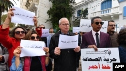 FILE - Tunisian journalists rally for press freedom, outside the SNJT national journalists' union in Tunis, on March 25, 2022. Journalists gathered on May 18, 2023, to protest anti-terror laws they say are being used against them.