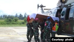 Para anggota TNI membawa peti berisi jenazah rekannya yang gugur dalam serangan yang dilakukan oleh kelompok bersenjata di Nduga, Papua, dalam proses evakuasi menuju Timika, pada 27 Maret 2022. (Foto: Pendam XVII/Cenderawasih Papua)