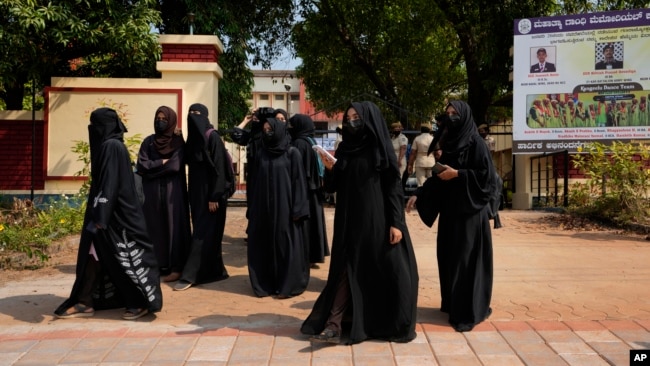 Indian Muslim students wearing burqas leave Mahatma Gandhi Memorial college after they were denied entry into the campus in Udupi, Karnataka state, India, Feb. 24, 2022. (AP Photo/Aijaz Rahi)