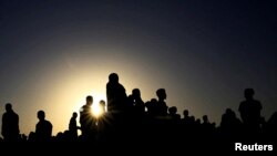 FILE - People who fled fighting in Ethiopia's Tigray region gather near the Sudan-Ethiopia border, Nov. 22, 2020. 