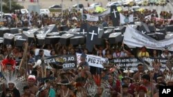 Indigenous protesters from various ethnic groups carry fake coffins representing indians killed over the demarcation of land, as they demand the demarcation of indigenous lands, outside the National Congress in Brasilia, Brazil, April 25, 2017.