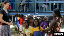 In this file photo, Australian aboriginal school children line up to receive free laptop computers in Elcho, Island May 27, 2009. 