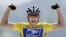 FILE - Lance Armstrong raises his arms as he crosses the finish line to win a stage of the Tour de France, July 2004. 