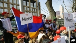 Activists of an Armenian youth group gather at the French Embassy in Yerevan to express their gratitude to France's parliament for passing a bill that outlaws denial of Armenian genocide, in Yerevan, Armenia, January 24, 2012