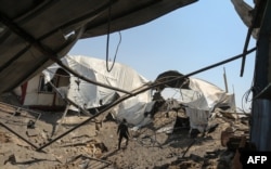 A man inspects the damage at a site targeted by an Israeli airstrike a day before in Khan Younis in the southern Gaza strip on May 30, 2018.