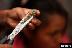 Mari Teteche, 42, prepares marijuana harvested in the mountains of Tacueyo, Cauca, Colombia, Feb. 10, 2016.