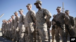 FILE - In this Jan. 15, 2018, file photo, U.S. Marines watch during the change of command ceremony at Task Force Southwest military field in Shorab military camp of Helmand province, Afghanistan. Afghan forces backed by U.S. troops in Afghanistan’s…