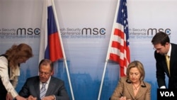 Menteri Luar Negeri AS Hillary Clinton (kanan) dan Menlu Rusia Sergei Lavrov menandatangani pertukaran dokumen resmi START di sela-sela Konferensi Keamanan di Munich, Jerman.