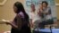 A job seeker looks over a brochure at the National Job Fair in Atlanta, Oct 3, 2012. 
