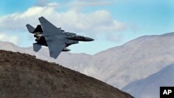 FILE - An F-15E Strike Eagle from Seymour Johnson AFB in North Carolina flies out of the nicknamed "Star Wars Canyon" turning toward the Panamint range over Death Valley National Park, California, Feb. 27, 2017.