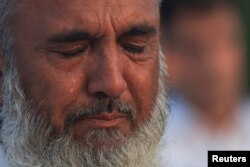 A man mourns as he attends funeral prayers in absentia after the assassination of Hamas leader Ismail Haniyeh in Iran, in Peshawar, Pakistan, July 31, 2024.