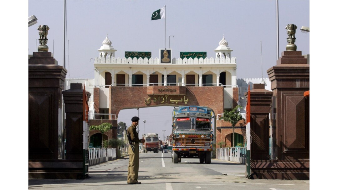 FILE - An Indian border security force soldier stands guard as an Indian truck, exporting goods to Pakistan, returns back towards the Indian side of joint check post between India and Pakistan at Wagah, India.