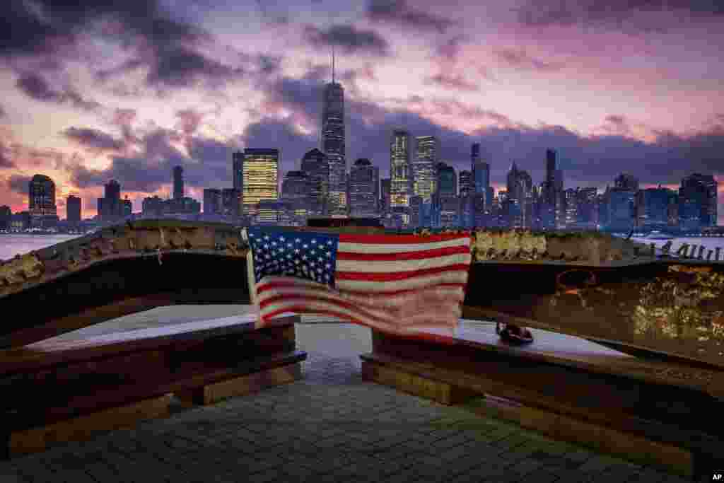 A U.S. flag hanging from a steel girder, damaged in the Sept. 11, 2001 attacks on the World Trade Center, blows in the breeze at a memorial in Jersey City, New Jersey, Sept. 11, 2019