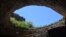 Birds circle the entrance of a cave at Carlsbad Caverns National Park in New Mexico. 