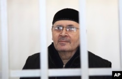 FILE - Oyub Titiyev, the head of regional branch of Russian human rights group Memorial, attends a court hearing in Grozny, Russia, March 6, 2018.